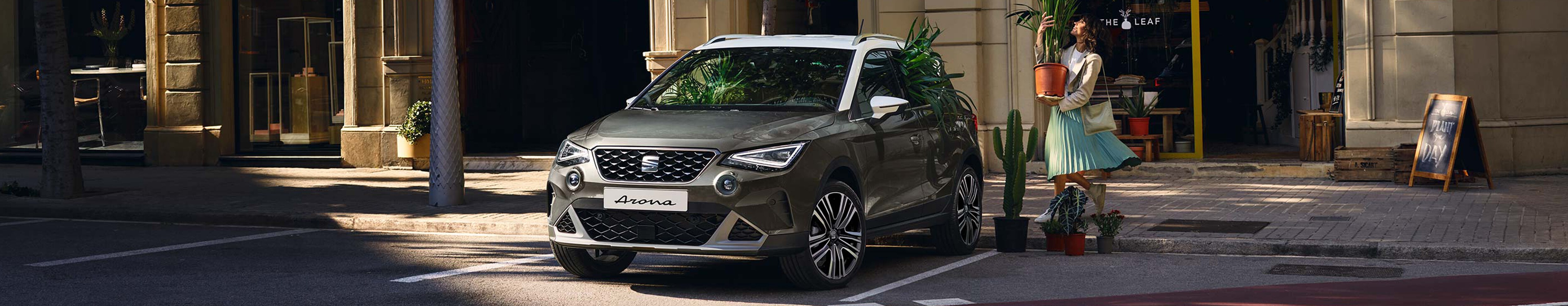 desire red SEAT Arona outdoor side angle view