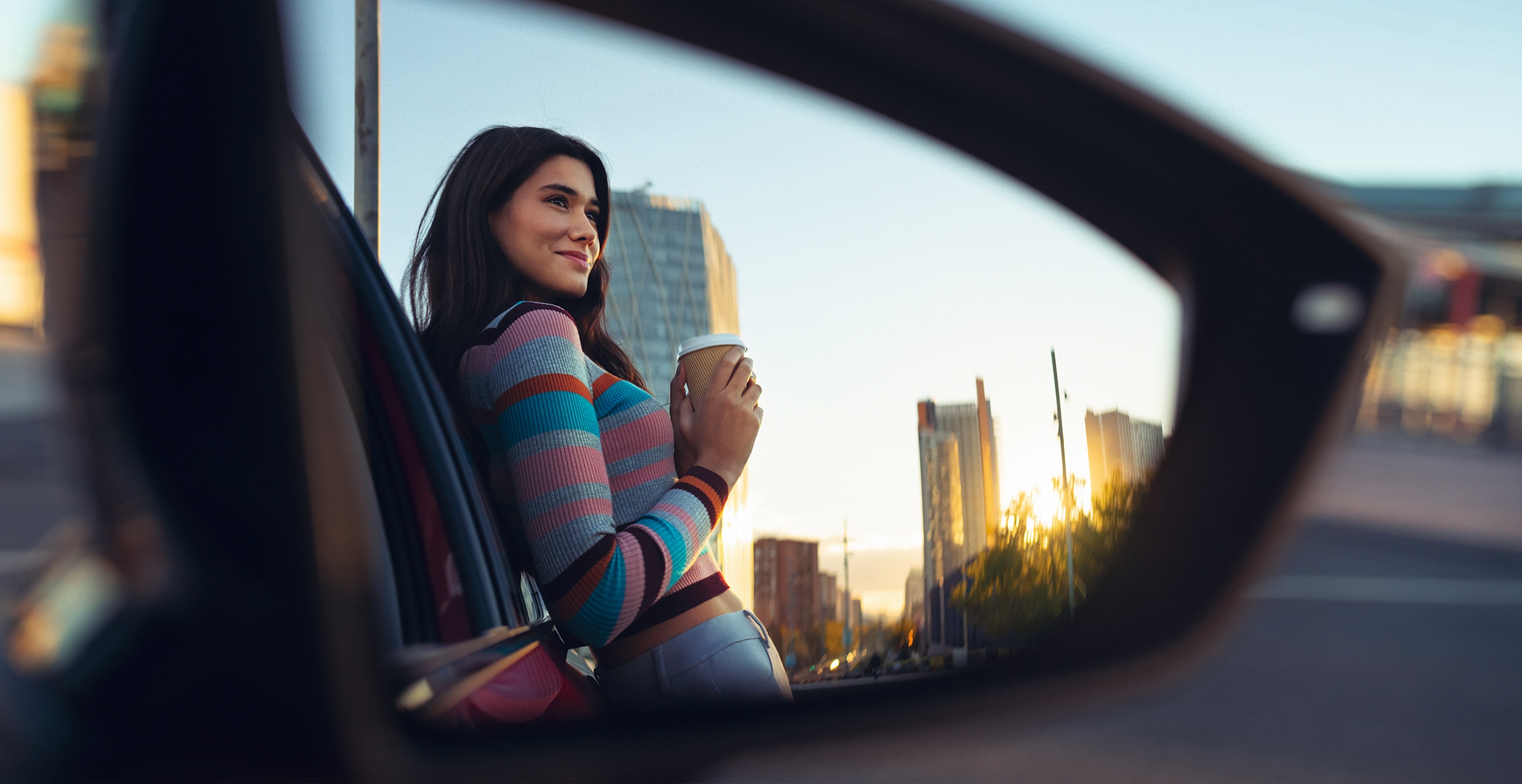 Young couple lying on a hill taking a selfie in sunshine – SEAT Used car warranty deals